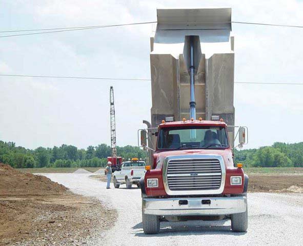 Truck with dump box caught on high voltage power lines, from the front